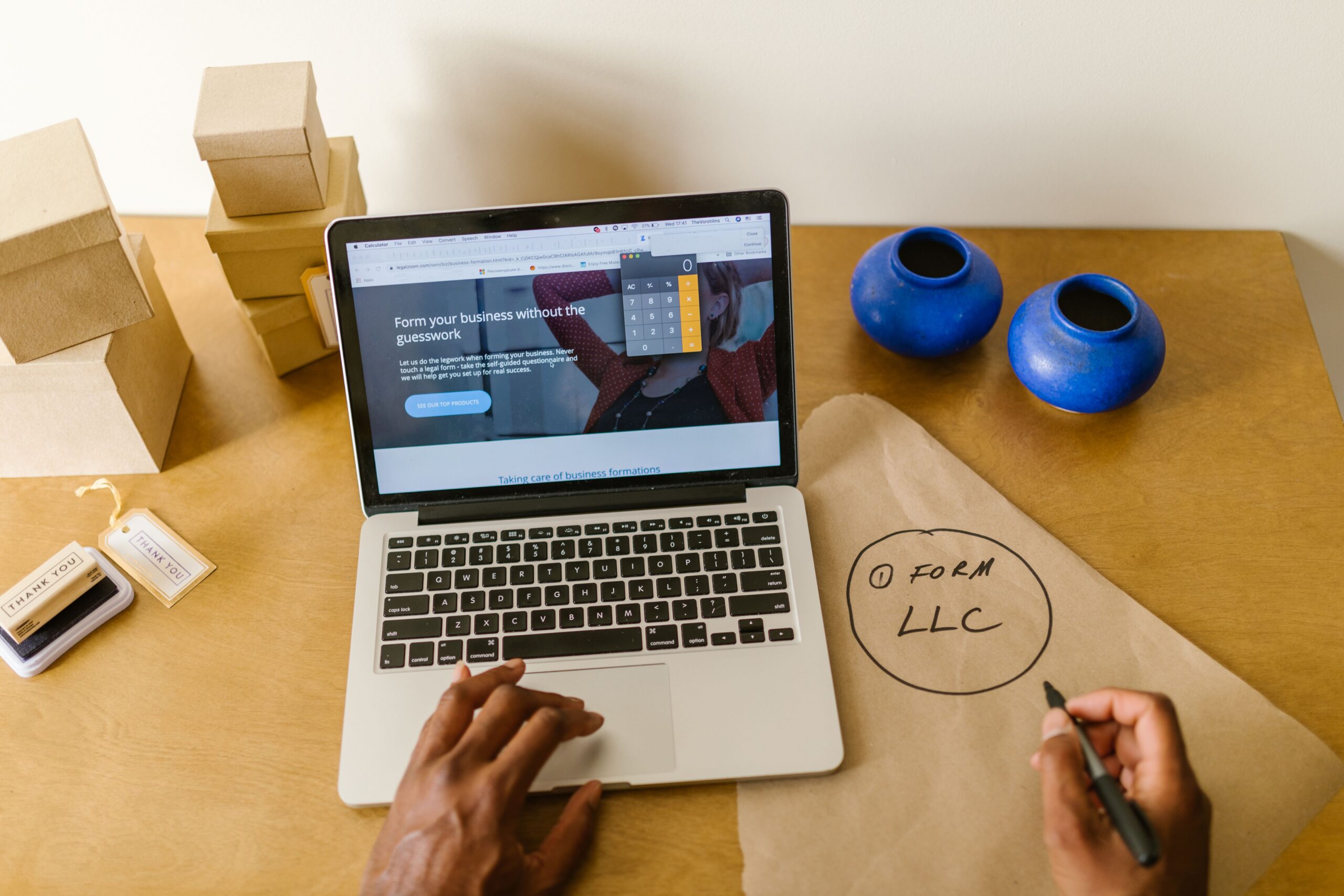 Business owner reviewing company finances and planning growth on a laptop while evaluating how many lines of credit should you have for future funding needs.